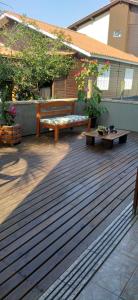 a wooden deck with two benches on a house at Casa da Barra da Ibiraquera in Imbituba