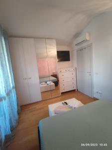 a bedroom with a bed and a dresser and a mirror at Tuscan Gallery House in Grosseto