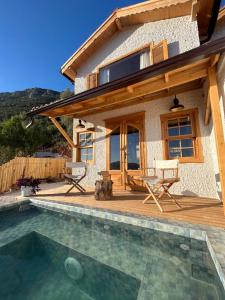a house with a swimming pool in front of a house at Loft Country Kaş in Kaş