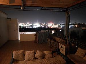 a room with a view of a city at night at House of Dreams apartments Luxor in Luxor