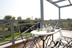 a patio with a table and chairs on a balcony at Villa Simeoni in Lefkada