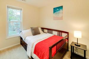 a small bedroom with a bed and a window at Havelock Townhome with Patio about 8 Miles to River in Havelock
