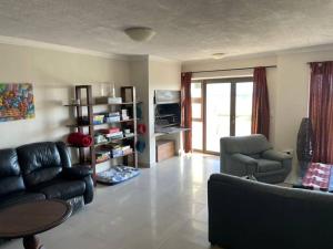 a living room with a couch and a chair at Namibia Coastal Retreat in Walvis Bay