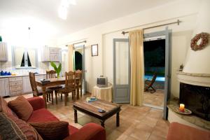 a living room with a fireplace and a table at Villa Simeoni in Lefkada