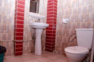 a bathroom with a sink and a toilet at SUP HOTEL in Douala