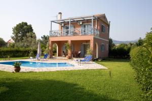a villa with a swimming pool and a house at Villa Simeoni in Lefkada