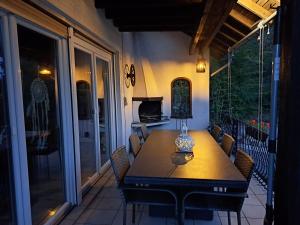 a table and chairs on a porch with a table at Forsthaus an der Cloef in Mettlach