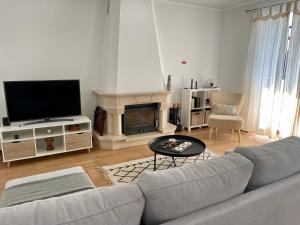 a living room with a couch and a fireplace at Baleeiro do Cais:Harbour House, Fishing, Fireplace in Ponta Delgada