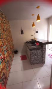 a kitchen with a stove and a counter top at Studio Aconchegante in Palmas