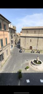 a street with a fountain in the middle of a city at Il Viterbino Struttura convenzionata con impianti termali in Viterbo