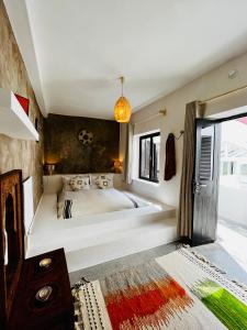 a bedroom with a large white tub in a room at Riad Dar Sebta in Essaouira