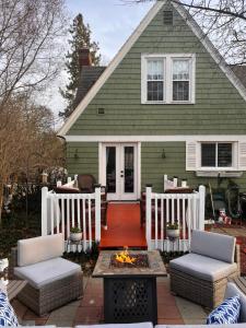 a house with a patio with a fire pit at Cozy Cape Cod in Grand Rapids