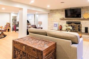 ein Wohnzimmer mit einem Sofa und einem Kamin in der Unterkunft 2-Acre Highland Park Retreat with Heated Pool ~ 5* in Highland Park