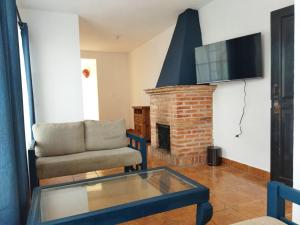 - un salon avec un canapé et une cheminée dans l'établissement Hotel & Hostal Santuario, à San Miguel de Allende