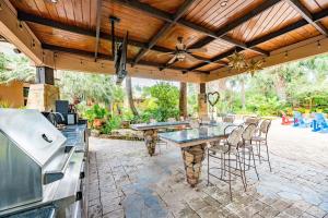 an outdoor kitchen and dining area with a table and chairs at Casa Rayo de Sol - Private ranch guest home in Mission