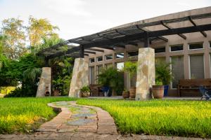 a building with a stone pathway in front of a yard at Casa Rayo de Sol - Private ranch guest home in Mission