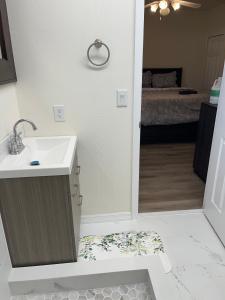 a bathroom with a sink and a room with a bed at ZenHomes in Brandon near Tampa Valrico Seffner in Brandon +21 photos
