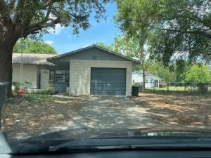 a house with a garage with a driveway at ZenHomes in Brandon near Tampa Valrico Seffner in Brandon