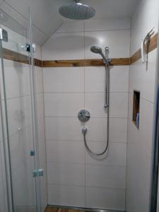 a shower with a shower head in a bathroom at Ferienwohnung Boahof in Lessach