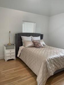 a bedroom with a bed with a nightstand and a bed sidx sidx sidx sidx at Stylish, 2 Bedroom in Houston-Bellaire in Houston