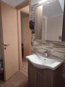 a bathroom with a sink and a mirror at Modern House in Mytilene Center in Mytilini