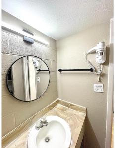 a bathroom with a sink and a mirror at Super 8 by Wyndham Blythe in Blythe