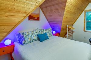 uma cama num quarto com tecto em madeira em Adorable A-Frame Cabin, Steps to Lake Cushman! em Hoodsport