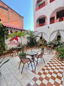 a patio with tables and chairs in a building at Hotel Firenze in Tarapoto