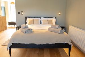 a bedroom with a large bed with towels on it at Tryfan - Snowdonia, North Wales in Bethesda