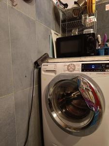a washing machine with a towel on top of it at 10 Coins Hostel & tours in Sofia