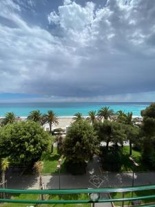 a view of the beach and the ocean from a balcony at Hotel Alba Chiara in Finale Ligure