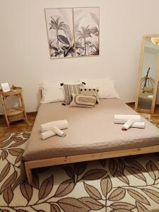 a large bed with two pillows on it in a room at Vichome in Catania