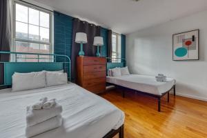 two beds in a room with blue and white at The Stairway Suites - Convention Center in Philadelphia