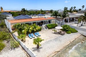an aerial view of a house with a beach at Oceanfront - Villa Port of Call - in Kralendijk