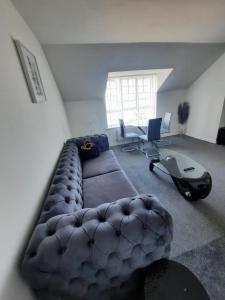 a living room with a couch and a desk at River View Two Bed Room Luxury Apartment in Thamesmead