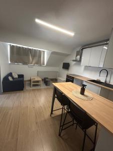 a kitchen and living room with a table and a couch at Elegance & Comfort Brand New Apartment near to Atomium in Brussels
