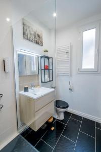 a bathroom with a sink and a toilet at Wellness Bubble - Cathédrale - Hypercentre in Reims