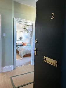 a door leading to a bedroom with a bed at Pier View Felixstowe - Sea View, 50m from the beach in Felixstowe