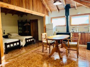 une chambre avec une table et une chambre avec un lit dans l'établissement Fly Fishing Cabin, River Coast., à Los Helechos
