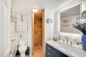 a bathroom with a toilet and a sink and a shower at Eureka Vacation Rental Steps to Creek and Fishing! in Eureka +16 photos