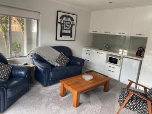 a living room with a couch and a coffee table at HotelSuse in Napier