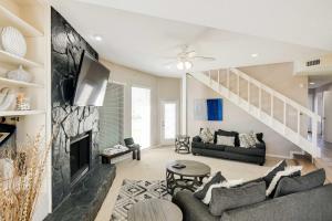 a living room with a couch and a fireplace at Pet-Friendly Galveston Home with Wraparound Deck in Galveston