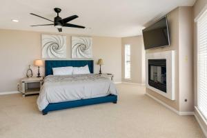 una camera con letto blu e TV a schermo piatto di Pet-Friendly Galveston Home with Wraparound Deck a Galveston