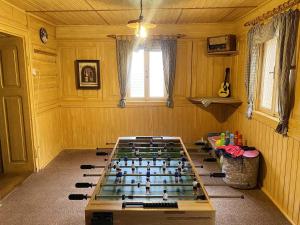 a room with a pool table in the middle of it at Chata Zvoneček in Jiřetín pod Jedlovou