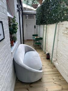 a large white couch sitting on a patio at Charming Studio Apartment in London in London