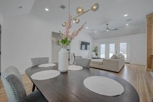 a dining room table with chairs and a vase with flowers at Stylish, 2 Bedroom in Houston-Bellaire in Houston