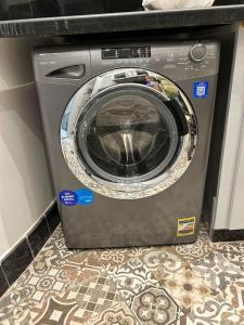 a washing machine sitting on the floor in a kitchen at Charming luxurious 2 bedroom apartment in zamalek in Cairo