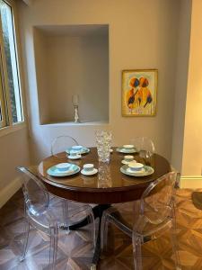 a dining room table with four chairs around it at Charming luxurious 2 bedroom apartment in zamalek in Cairo