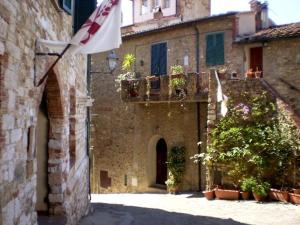 an old building with an american flag in a courtyard at Casa Guerrieri in Suvereto