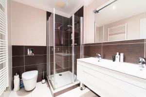 a bathroom with a shower and a toilet and a sink at Prague Marina River View Apartment Close To City Centre FREE PARKING in Prague